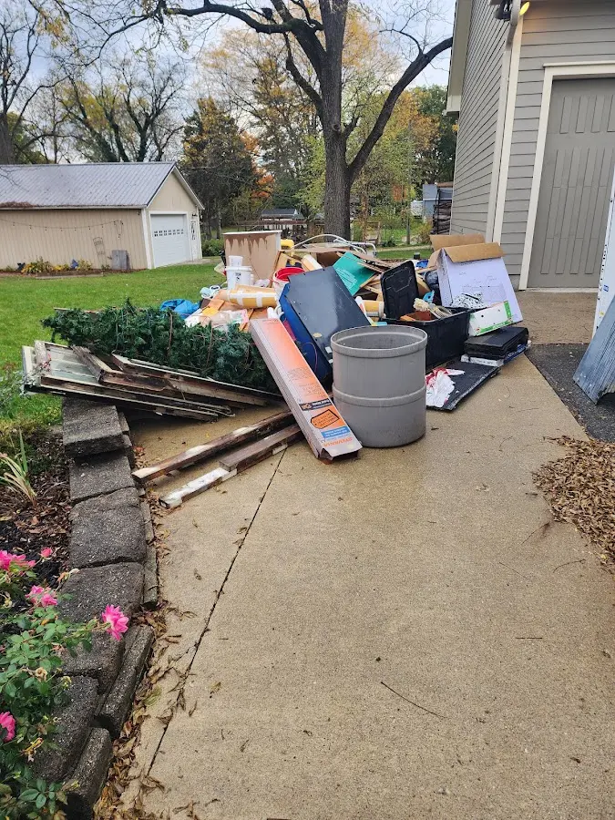Dumpster being loaded with debris for Estate Cleanout Dumpster Rental in Arlington Heights